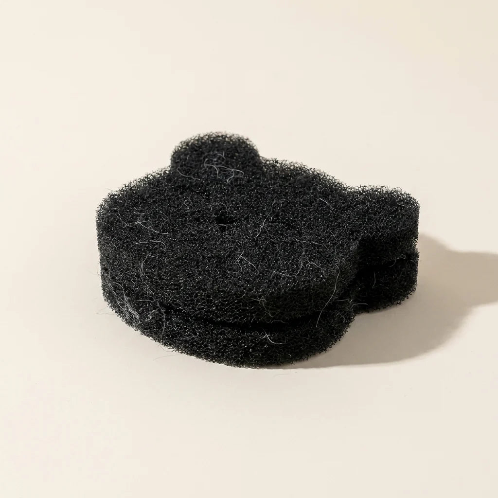 Laundry pet hair catcher shown with collected pet fur lifted from clothing