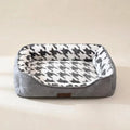 Grey square bolster dog bed with raised sides and a low front edge